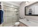 Modern bathroom featuring a glass-enclosed shower, a sleek vanity, and contemporary fixtures at 9950 62Nd N Ter # 203, St Petersburg, FL 33708