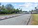 Bocce ball court area with tables, umbrellas and a fence surrounding the green area at 9950 62Nd N Ter # 203, St Petersburg, FL 33708