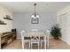 Cozy dining room features modern light fixture, wood floors and bead board accents at 9950 62Nd N Ter # 203, St Petersburg, FL 33708