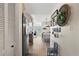 Hallway view into dining space showcases updated flooring, fixtures, and decor at 9950 62Nd N Ter # 203, St Petersburg, FL 33708