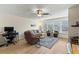 Inviting living room featuring a comfortable sofa, recliner, stylish rug, and bright window at 9950 62Nd N Ter # 203, St Petersburg, FL 33708