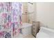 Bathroom featuring a shower-tub combo, tiled walls, and storage at 10159 Hernando Ridge Rd, Weeki Wachee, FL 34613