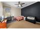 Cozy bedroom with a black accent wall, single bed, a desk and a ceiling fan at 10159 Hernando Ridge Rd, Weeki Wachee, FL 34613