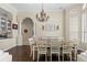 Beautiful dining room featuring a chandelier, pillars, and a dining table for six at 10159 Hernando Ridge Rd, Weeki Wachee, FL 34613