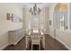 Bright dining room with a bay window, chandelier, and elegant wood floors at 10159 Hernando Ridge Rd, Weeki Wachee, FL 34613