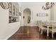 Elegant dining room with hardwood floors, chandelier, and seamless flow into the kitchen at 10159 Hernando Ridge Rd, Weeki Wachee, FL 34613