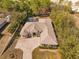 Aerial view of a beautiful single-story home with a screened-in pool, lush greenery, and circular driveway at 10159 Hernando Ridge Rd, Weeki Wachee, FL 34613