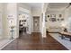 Welcoming foyer showcasing hardwood floors, a view of the office, and a cozy living room at 10159 Hernando Ridge Rd, Weeki Wachee, FL 34613