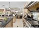 Modern kitchen featuring stainless steel appliances, granite countertops, and an open layout to the living area at 10159 Hernando Ridge Rd, Weeki Wachee, FL 34613