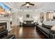 Spacious living room featuring hardwood floors, a fireplace, tray ceilings, and neutral decor at 10159 Hernando Ridge Rd, Weeki Wachee, FL 34613