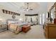 This main bedroom features a tray ceiling, sitting area, and stylish decor at 10159 Hernando Ridge Rd, Weeki Wachee, FL 34613