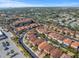 Aerial view showcases the neighborhood's tree-lined streets and proximity to nearby city amenities at 10193 Grand Oak Cir, Madeira Beach, FL 33708