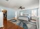 Main bedroom features hardwood floors, ceiling fan, walk-in closet, and bright, neutral paint at 10193 Grand Oak Cir, Madeira Beach, FL 33708