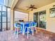 Covered outdoor space offers a dining bar, ceiling fan, and brick-paved flooring, ideal for enjoying the fresh air at 10193 Grand Oak Cir, Madeira Beach, FL 33708