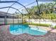 Backyard pool is screened-in, features a brick border, and provides a refreshing oasis for relaxation and recreation at 10193 Grand Oak Cir, Madeira Beach, FL 33708