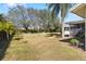 Lush backyard featuring a hammock, mature trees, and well-maintained lawn at 10222 95Th St, Seminole, FL 33777