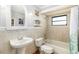 Cozy bathroom featuring tiled walls, a pedestal sink, and a shower-tub combination at 10222 95Th St, Seminole, FL 33777