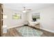 Bright bedroom featuring wood floors, a ceiling fan, and a desk near a window at 10222 95Th St, Seminole, FL 33777