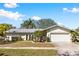 Inviting single-story home with a lush front yard and attached garage at 10222 95Th St, Seminole, FL 33777