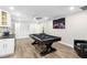 Spacious recreation room featuring a billiards table, custom built in cabinets, and modern lighting fixtures at 10222 95Th St, Seminole, FL 33777