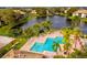 Aerial view of the community, showcasing the pool, landscaping, and surrounding lakes at 10265 Gandy N Blvd # 1806, St Petersburg, FL 33702