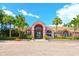 Elegant clubhouse entrance featuring palm trees and a stylish brick-paved drive at 10265 Gandy N Blvd # 1806, St Petersburg, FL 33702