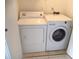 Laundry closet with a side by side washer and dryer on tiled floor at 10265 Gandy N Blvd # 1806, St Petersburg, FL 33702