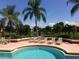 Relaxing pool area with surrounding chairs and a view of the tranquil community lake at 10265 Gandy N Blvd # 1806, St Petersburg, FL 33702