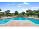 Beautiful community pool with waterfall feature, surrounded by lush landscaping and lounge chairs at 10265 Gandy N Blvd # 1806, St Petersburg, FL 33702