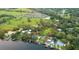 Aerial view featuring the property's waterfront, boating dock, and nearby neighborhood in a beautiful natural setting at 10501 Bridgewood Dr, Riverview, FL 33578