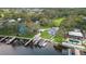 An aerial view showcasing multiple homes with private boat docks, mature trees, and waterfront access on a clear day at 10501 Bridgewood Dr, Riverview, FL 33578