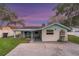 Charming single-story home featuring a covered porch, blue trim, and well-maintained lawn at 10501 Bridgewood Dr, Riverview, FL 33578