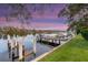 Scenic waterfront view featuring a private dock with seating and lush green surroundings at 10501 Bridgewood Dr, Riverview, FL 33578