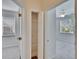 Hallway closet with wire shelving positioned between two bedrooms with neutral carpeting at 11542 Captiva Kay Dr, Riverview, FL 33569