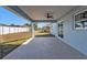 Covered concrete patio with ceiling fan and view of backyard at 13526 Alberta Ave, Port Charlotte, FL 33981