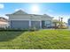 Charming single-story home with a well-manicured lawn, a two-car garage, and stone accents at 17020 Cape Horn Blvd, Punta Gorda, FL 33955