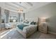 Serene main bedroom featuring tray ceilings, large windows, and a calming color palette at 17020 Cape Horn Blvd, Punta Gorda, FL 33955