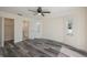 Bright bedroom with ceiling fan, gray flooring, and ensuite bathroom at 17319 Terry Ave, Port Charlotte, FL 33948