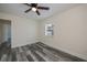 Bright bedroom with gray flooring, ceiling fan, and fresh, neutral paint at 17319 Terry Ave, Port Charlotte, FL 33948