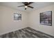 Bedroom features stylish gray flooring, a ceiling fan, and natural light at 17319 Terry Ave, Port Charlotte, FL 33948