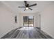 Sunny bedroom featuring stylish gray floors, a sliding glass door, and ceiling fan at 17319 Terry Ave, Port Charlotte, FL 33948