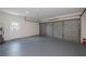 Spacious garage with epoxy floor, overhead door, and service door at 17319 Terry Ave, Port Charlotte, FL 33948