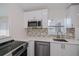 Bright kitchen featuring stainless steel appliances, white cabinets, and light countertops at 17319 Terry Ave, Port Charlotte, FL 33948