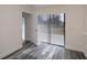 A bright room with modern flooring and vertical blinds covering the sliding glass door at 17319 Terry Ave, Port Charlotte, FL 33948