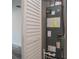 Utility closet with HVAC system and white louvered door at 17319 Terry Ave, Port Charlotte, FL 33948