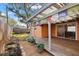 View of the back porch with stone landscaping, wooden deck, and sliding glass door at 1818 53Rd S St, Gulfport, FL 33707