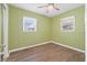 Empty bedroom with ceiling fan, two windows, and wood-look flooring at 1818 53Rd S St, Gulfport, FL 33707