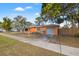 View of the home's exterior showing the grey garage door, sidewalk, and driveway at 1818 53Rd S St, Gulfport, FL 33707