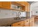 Kitchen counter with stainless steel sink, wood cabinets, and granite countertops at 1818 53Rd S St, Gulfport, FL 33707