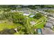 Aerial view of community amenities including pool, playground, tennis court, and lakeside pier at 18329 Roseate Dr, Lutz, FL 33558